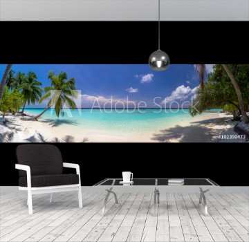 Picture of Beach panorama at Maldives with blue sky palm trees and turquoi